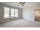 Spacious bedroom with natural light, ceiling fan, and neutral carpet flooring at 63 W Victoria Ridge Dr # 31, Selma, NC 27576
