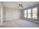 Bright and spacious bedroom with three windows and a ceiling fan at 63 W Victoria Ridge Dr # 31, Selma, NC 27576