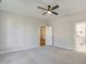Bright bedroom features a ceiling fan, light gray carpet, and an ensuite bathroom at 63 W Victoria Ridge Dr # 31, Selma, NC 27576