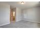 This light-filled bedroom gives a view of a bathroom and a closet; it has gray walls and gray carpet at 63 W Victoria Ridge Dr # 31, Selma, NC 27576