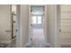 Hallway view into bedroom showcasing neutral color palette, carpeted floor, and natural light from window at 63 W Victoria Ridge Dr # 31, Selma, NC 27576