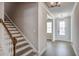 Entryway with a staircase and an open view of the front door and a window at 63 W Victoria Ridge Dr # 31, Selma, NC 27576