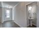 Elegant entryway features a decorative chandelier, light gray walls, and a stylish powder room with pedestal sink at 63 W Victoria Ridge Dr # 31, Selma, NC 27576