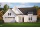 Charming exterior elevation of a white farmhouse-style home with a two-car garage and beautiful landscaping at 63 W Victoria Ridge Dr # 31, Selma, NC 27576
