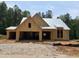 Unfinished exterior of a single-story home with a two-car garage and a gabled roof under construction at 63 W Victoria Ridge Dr # 31, Selma, NC 27576