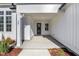 Inviting covered front porch with a stylish black front door and modern design elements at 63 W Victoria Ridge Dr # 31, Selma, NC 27576