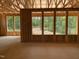 Partially framed interior showcasing window placement and surrounding wooded views at 63 W Victoria Ridge Dr # 31, Selma, NC 27576