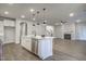 Bright kitchen with white cabinets, stainless steel appliances, and a large island with pendant lighting at 63 W Victoria Ridge Dr # 31, Selma, NC 27576