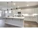 Stylish kitchen with white cabinets, stainless steel appliances, a center island, and pendant lighting at 63 W Victoria Ridge Dr # 31, Selma, NC 27576