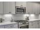 This is a beautiful chef's kitchen featuring stainless appliances and a stylish herringbone backsplash at 63 W Victoria Ridge Dr # 31, Selma, NC 27576