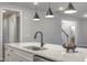 Close-up of the kitchen island featuring stainless steel appliances, a sink, and a black faucet at 63 W Victoria Ridge Dr # 31, Selma, NC 27576