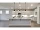 Modern kitchen with white cabinets, stainless steel appliances, and a large center island with pendant lighting at 63 W Victoria Ridge Dr # 31, Selma, NC 27576