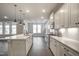 Open kitchen with island, stainless steel appliances, quartz countertops, and wood floors at 63 W Victoria Ridge Dr # 31, Selma, NC 27576