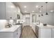 Well-lit kitchen featuring white cabinets, stainless steel appliances, and an island with marble countertops at 63 W Victoria Ridge Dr # 31, Selma, NC 27576