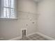 Laundry room with tile flooring, window and shelving at 63 W Victoria Ridge Dr # 31, Selma, NC 27576
