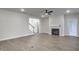 Open-concept living room with hardwood floors, fireplace, and views of the kitchen and staircase at 63 W Victoria Ridge Dr # 31, Selma, NC 27576