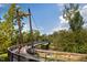 Scenic view of community walking bridge and cyclist amid lush greenery and flowing river at 63 W Victoria Ridge Dr # 31, Selma, NC 27576