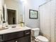 Well-lit bathroom featuring a decorative shower curtain and lovely framed wall art at 6341 Grace Lily Dr, Raleigh, NC 27607
