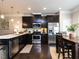 Modern kitchen with dark cabinetry, stainless steel appliances, and a breakfast bar at 6341 Grace Lily Dr, Raleigh, NC 27607