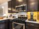 Close up of the stove, microwave, toaster and counter space in the kitchen at 6341 Grace Lily Dr, Raleigh, NC 27607