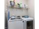 Well-equipped laundry room with modern washer, dryer and shelving at 6341 Grace Lily Dr, Raleigh, NC 27607