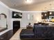 Cozy living room with a fireplace, dark wood floors, and an adjacent kitchen at 6341 Grace Lily Dr, Raleigh, NC 27607