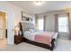 Serene main bedroom with tufted headboard, plush bedding, and ample natural light at 6341 Grace Lily Dr, Raleigh, NC 27607