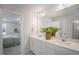 Bathroom featuring a double vanity with white countertops, complemented by a shower with marble tiling at 680 Beacon Hill Rd # 52, Lillington, NC 27546