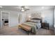 Bright bedroom with neutral color palette, features a ceiling fan, ensuite bathroom, and convenient laundry closet at 680 Beacon Hill Rd # 52, Lillington, NC 27546