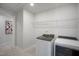 Modern laundry room with updated washer and dryer units, featuring ample shelving for storage at 680 Beacon Hill Rd # 52, Lillington, NC 27546
