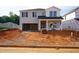 New two-story home showcasing gray siding, a two-car garage, and construction in progress on the front yard at 737 Deschutes Dr, Garner, NC 27529