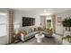 Comfortable living room with a large gray sectional, a decorative accent wall, and plenty of natural light at 737 Deschutes Dr, Garner, NC 27529