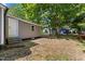 View of the side and back of the house featuring a lush, tree-filled backyard at 806 Martin Luther King Jr Dr, Smithfield, NC 27577