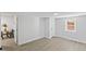 Bonus room features gray floors, wainscotting and view into kitchen and dining area at 806 Martin Luther King Jr Dr, Smithfield, NC 27577