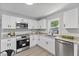 Well-lit kitchen features updated appliances, granite countertops, and ample cabinet space at 806 Martin Luther King Jr Dr, Smithfield, NC 27577