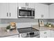 Modern kitchen appliances, microwave and stovetop with sleek granite countertops at 806 Martin Luther King Jr Dr, Smithfield, NC 27577