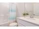 Bright bathroom featuring shower-tub combo with colorful curtain, modern sink, and plenty of natural light at 816 Still Willow Ln, Wendell, NC 27591