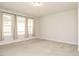 Spacious bedroom with plush carpeting, large windows, and neutral color palette at 816 Still Willow Ln, Wendell, NC 27591