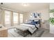 Staged bedroom featuring a bed, bench, decorations, and windows with coverings at 816 Still Willow Ln, Wendell, NC 27591