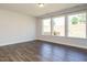 A bright bonus room features beautiful hardwood floors and three large windows, creating an inviting and airy atmosphere at 816 Still Willow Ln, Wendell, NC 27591