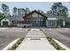 Beautiful community clubhouse featuring stone accents, gray siding, and a crosswalk for easy access at 816 Still Willow Ln, Wendell, NC 27591