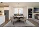 Cozy dining room with hardwood floors and a stylish table set for a meal, adjacent to a modern kitchen at 816 Still Willow Ln, Wendell, NC 27591