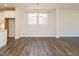 Dining area featuring hardwood floors, ample natural light, and a contemporary chandelier at 816 Still Willow Ln, Wendell, NC 27591