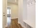 Entryway featuring coat rack with hooks, a built-in bench, and hardwood floors at 816 Still Willow Ln, Wendell, NC 27591