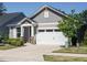 Attractive gray house with a white garage door and stone-accented entryway at 816 Still Willow Ln, Wendell, NC 27591