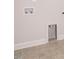 Functional laundry room hookups and gray tile flooring with white trim at 816 Still Willow Ln, Wendell, NC 27591