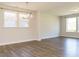 Bright living room with dark hardwood floors, large windows, and modern light fixture at 816 Still Willow Ln, Wendell, NC 27591