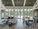 Bright community lounge area with vaulted ceilings, wood floors, comfortable seating, and views of the pool at 816 Still Willow Ln, Wendell, NC 27591