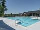 Large community swimming pool with a spacious deck and shaded lounge areas surrounded by greenery at 816 Still Willow Ln, Wendell, NC 27591