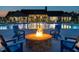 Enjoy the outdoor pool area and fire pit with comfortable lounge seating at dusk at 816 Still Willow Ln, Wendell, NC 27591